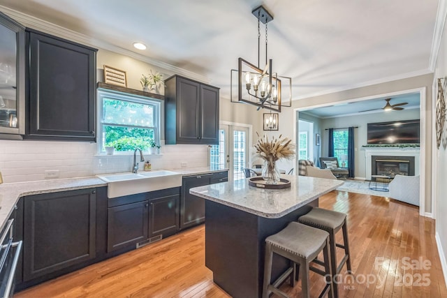 13312 Edgetree Dr, Pineville, NC 28134 - kitchen with a breakfast bar area, tasteful backsplash, light stone countertops, a sink, and black dishwasher