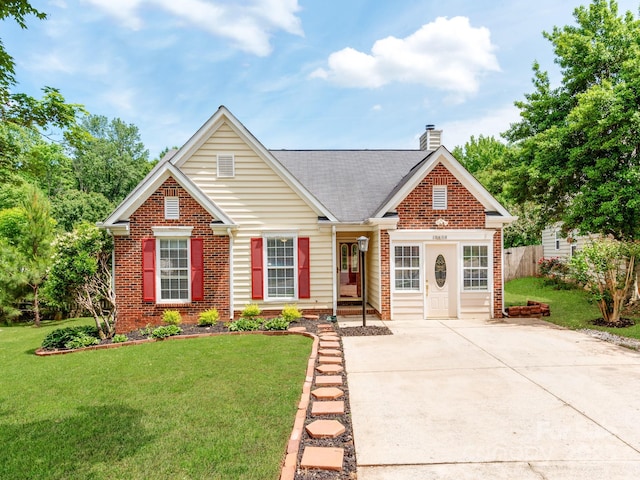 traditional-style house featuring brick siding, a chimney, driveway, and roof with shingles