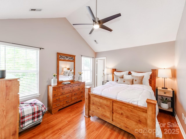 bedroom featuring high vaulted ceiling, light wood finished floors, and ceiling fan