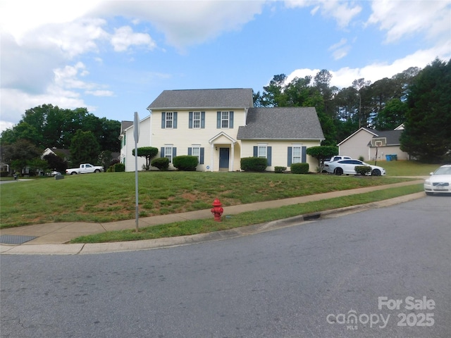 colonial inspired home with a front yard