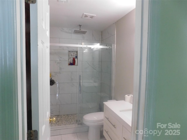 full bath with toilet, a stall shower, visible vents, tile patterned flooring, and vanity