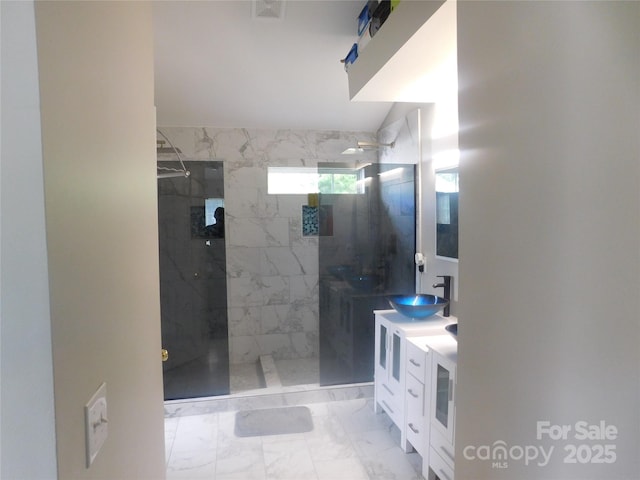 bathroom featuring a walk in shower, marble finish floor, and vanity