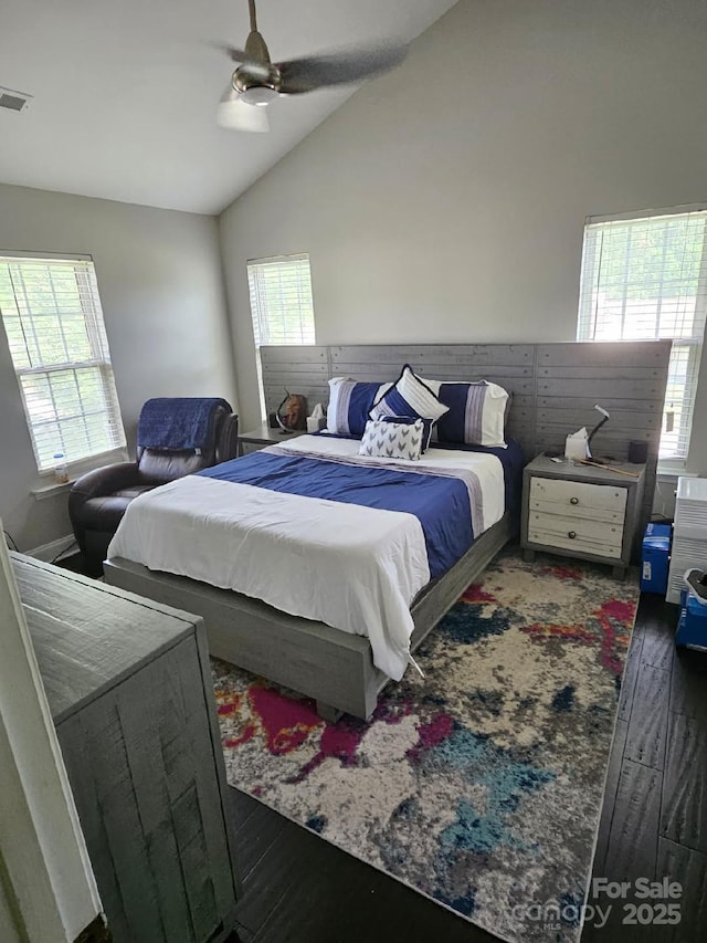 bedroom with ceiling fan, lofted ceiling, visible vents, and wood finished floors