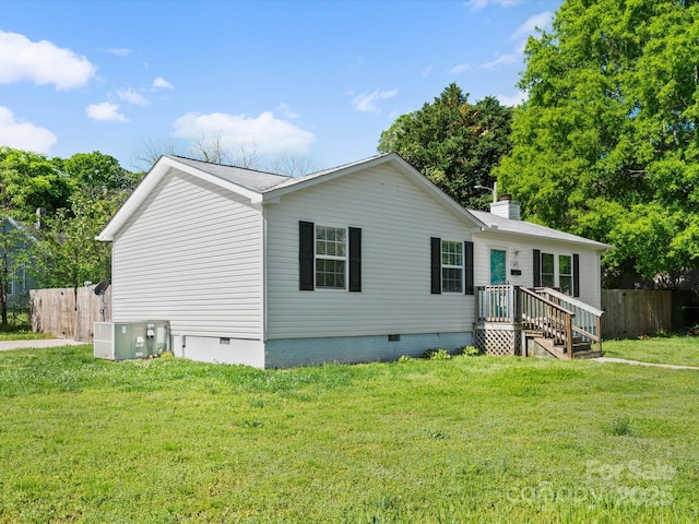 manufactured / mobile home featuring central AC, fence, a front lawn, and crawl space