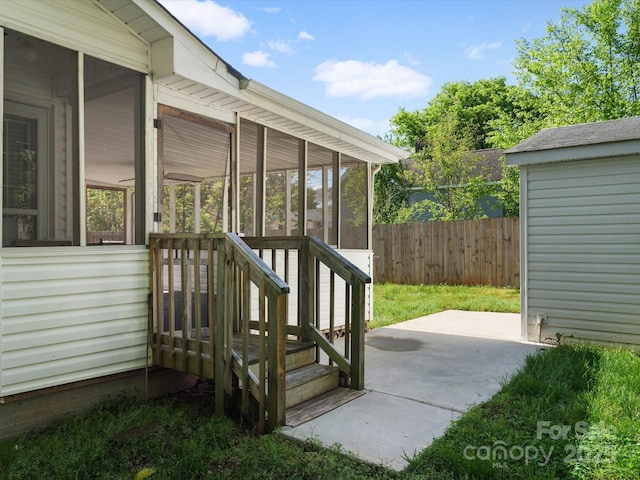 wooden terrace with a sunroom, a patio area, and fence