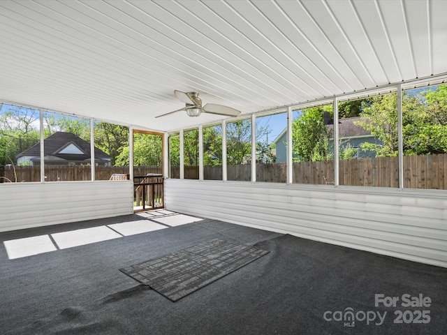unfurnished sunroom with a ceiling fan
