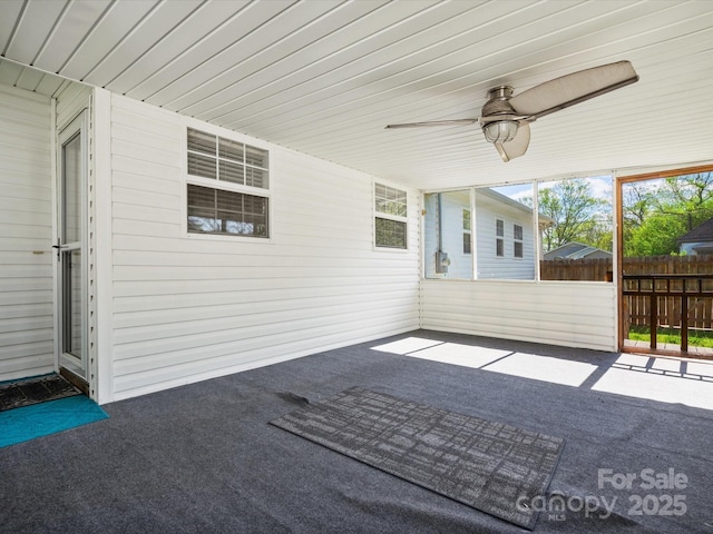 view of patio with fence and ceiling fan