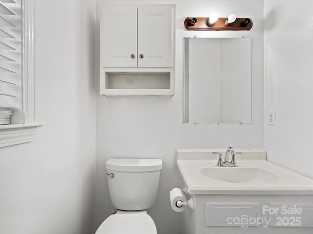 half bath with toilet and a sink