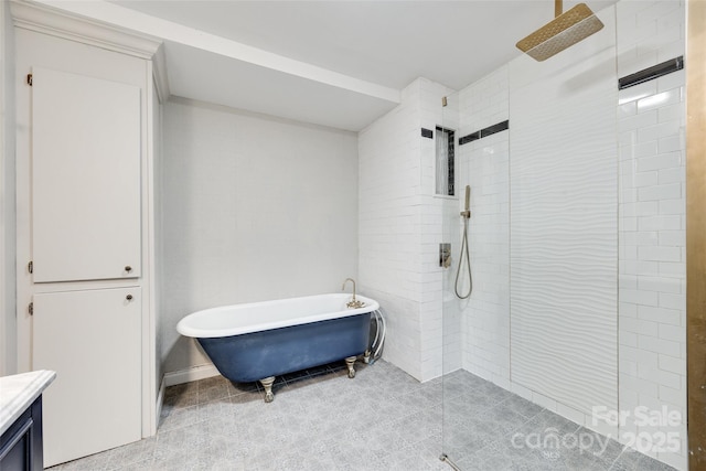 full bath with tile patterned flooring, a walk in shower, vanity, and a soaking tub
