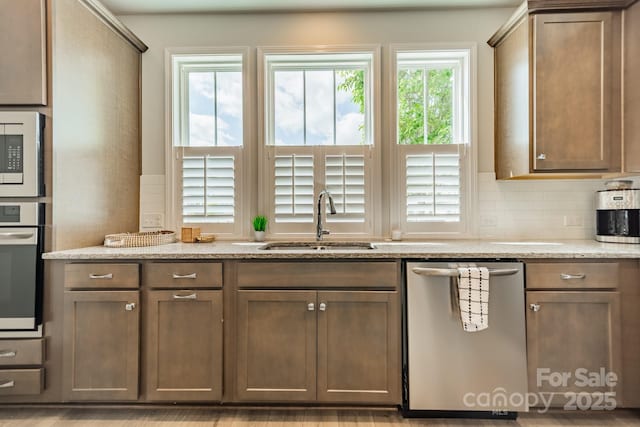 804 Lyndon Station Dr, Pineville, NC 28134 - kitchen with decorative backsplash, oven, white microwave, a sink, and dishwasher