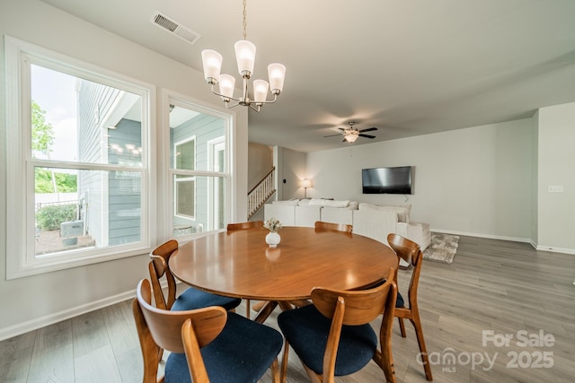 804 Lyndon Station Dr, Pineville, NC 28134 - dining space with visible vents, baseboards, ceiling fan with notable chandelier, and wood finished floors