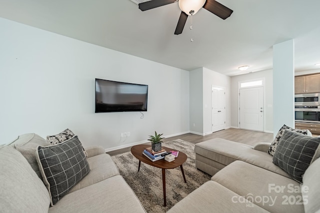 804 Lyndon Station Dr, Pineville, NC 28134 - living room featuring baseboards, a ceiling fan, and light wood finished floors