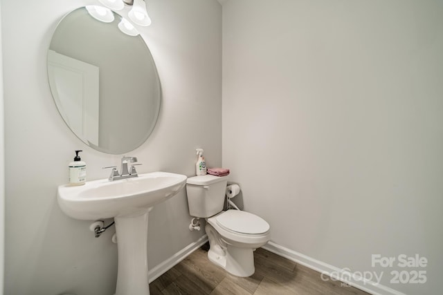 804 Lyndon Station Dr, Pineville, NC 28134 - bathroom featuring toilet, baseboards, and wood finished floors