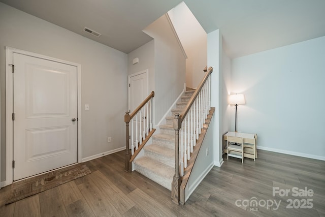804 Lyndon Station Dr, Pineville, NC 28134 - staircase featuring baseboards, visible vents, and wood finished floors
