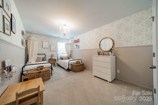 804 Lyndon Station Dr, Pineville, NC 28134 - bedroom featuring carpet floors, wainscoting, wallpapered walls, and a notable chandelier
