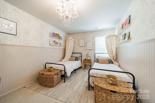 804 Lyndon Station Dr, Pineville, NC 28134 - bedroom with wallpapered walls, a notable chandelier, visible vents, and a wainscoted wall