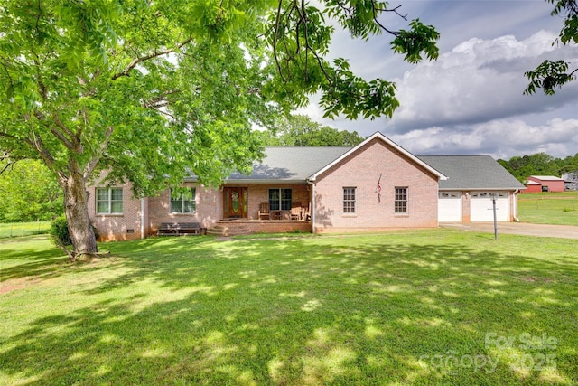 view of front of property featuring driveway, covered porch, a front yard, and brick siding
