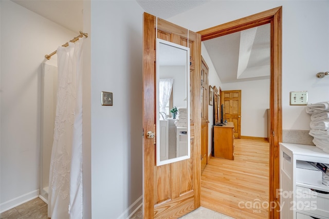 hall featuring baseboards