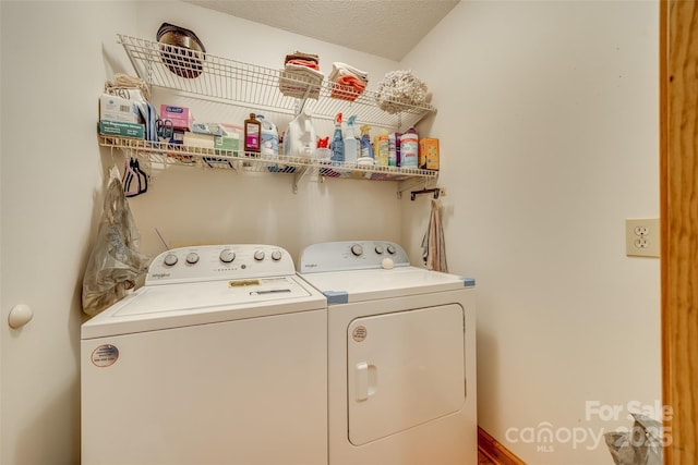 clothes washing area featuring laundry area and washer and clothes dryer
