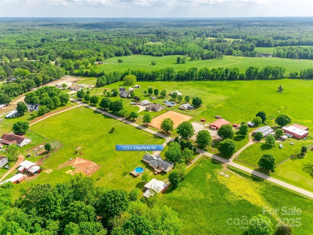 drone / aerial view with a wooded view