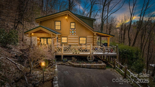 1873 El Miner Dr, Mars Hill, NC 28754 - back of property at dusk with log siding