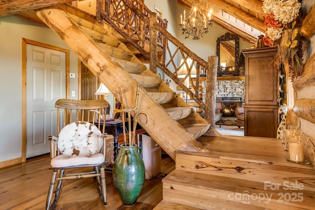 1873 El Miner Dr, Mars Hill, NC 28754 - stairway with a chandelier, hardwood / wood-style floors, and baseboards