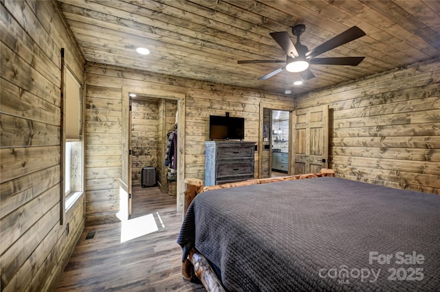 bedroom with wood ceiling, wood walls, and wood finished floors