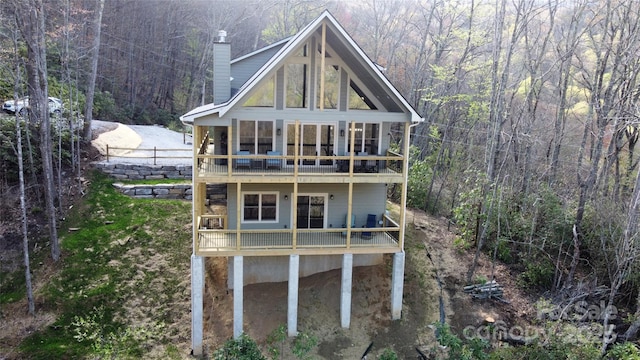 601 Tater Patch Rd, Maggie Valley, NC 28751 - back of property with a forest view, a chimney, a balcony, and a deck