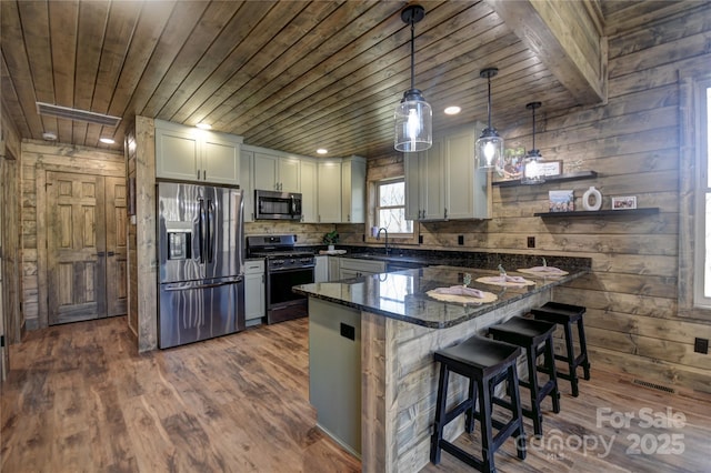 601 Tater Patch Rd, Maggie Valley, NC 28751 - kitchen featuring appliances with stainless steel finishes, wooden ceiling, a peninsula, dark wood-style flooring, and dark stone countertops