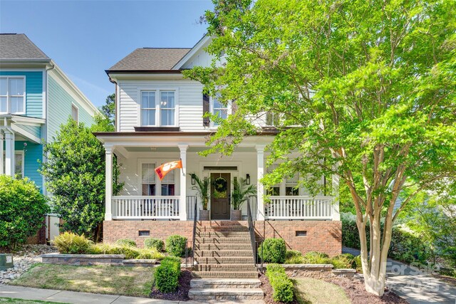 view of front of house featuring covered porch and stairway