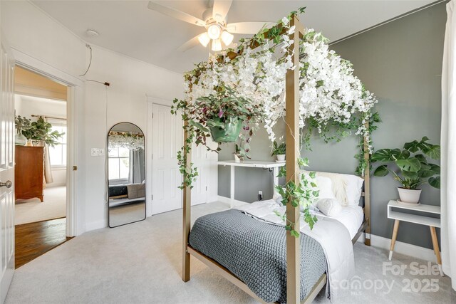 bedroom with baseboards, carpet, and a closet
