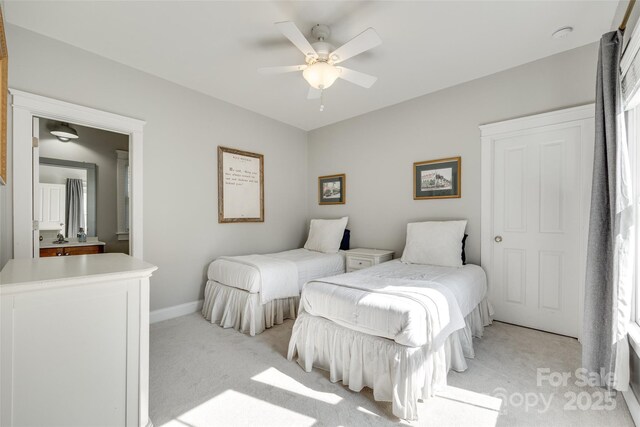 bedroom with baseboards, a ceiling fan, and light carpet