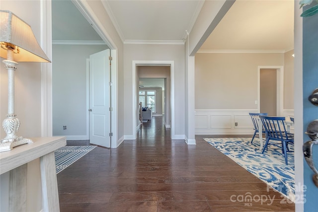 corridor featuring baseboards, dark wood-style flooring, and crown molding