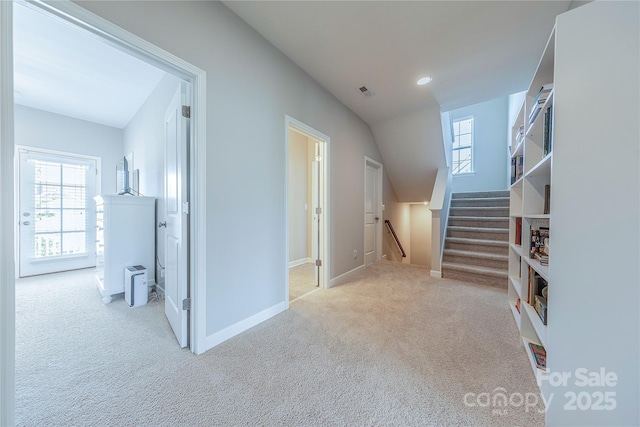 hallway featuring an upstairs landing, a wealth of natural light, carpet, and baseboards