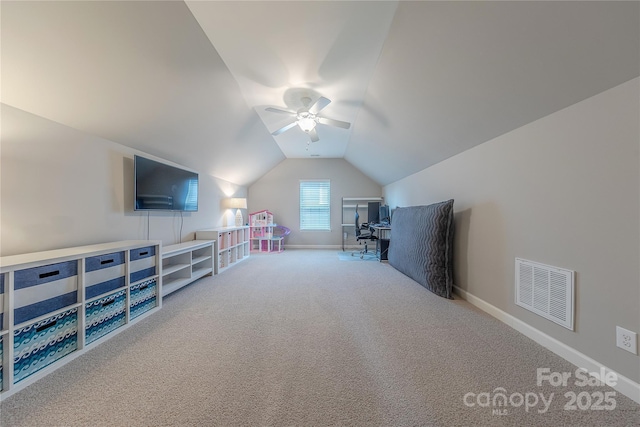 interior space featuring lofted ceiling, visible vents, ceiling fan, baseboards, and carpet floors