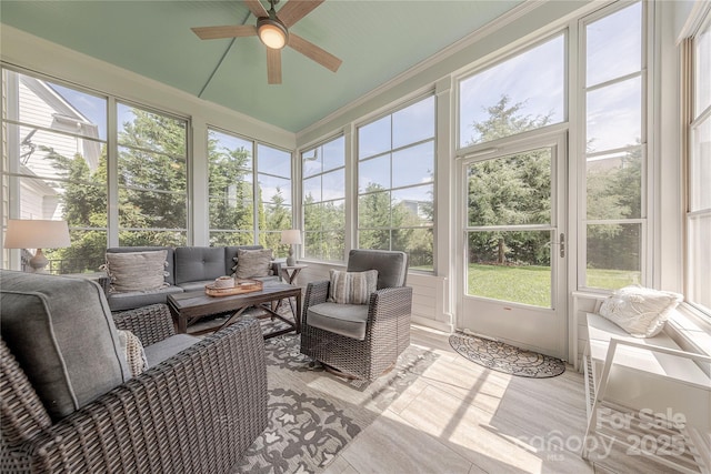 sunroom with a ceiling fan and outdoor lounge area