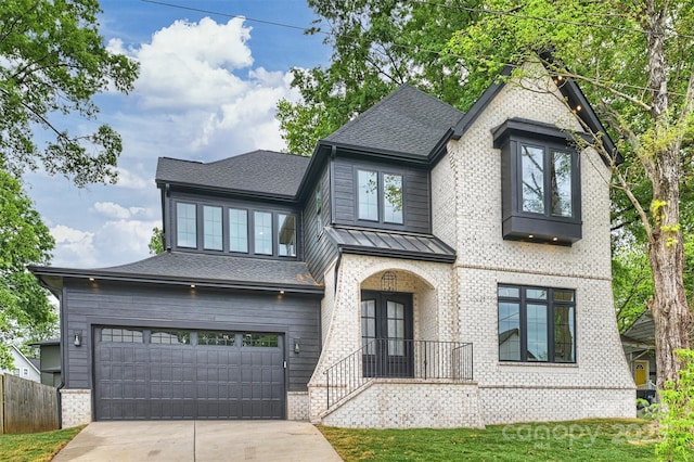 view of front of property with driveway, fence, a shingled roof, and an attached garage