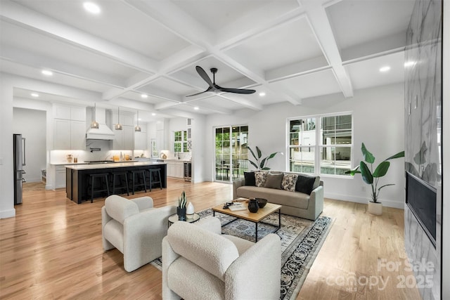 living area featuring recessed lighting, a ceiling fan, and coffered ceiling