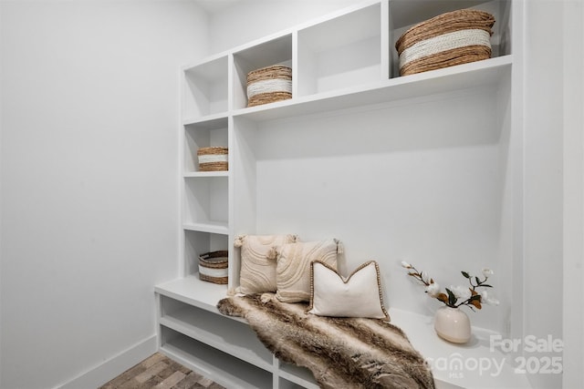 mudroom with wood finished floors and baseboards