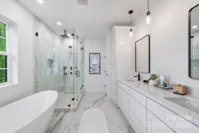 full bath with a sink, a marble finish shower, a freestanding bath, double vanity, and visible vents