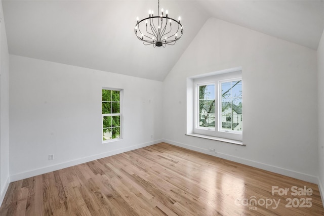 bonus room with a chandelier, high vaulted ceiling, wood finished floors, and a healthy amount of sunlight