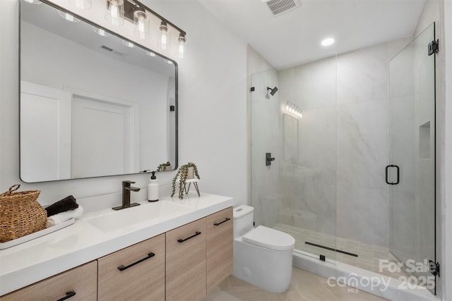 bathroom with vanity, visible vents, toilet, and a stall shower
