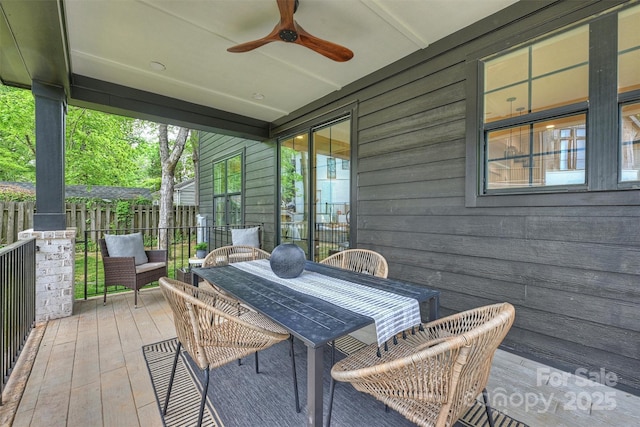 sunroom with outdoor dining space and ceiling fan