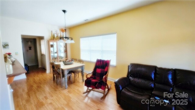 93 Foxden Dr Unit 101, Fletcher, NC 28732 - dining room with a chandelier, light wood-style flooring, and baseboards
