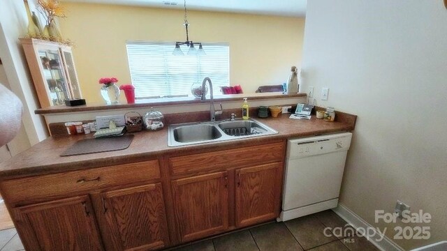 93 Foxden Dr Unit 101, Fletcher, NC 28732 - kitchen featuring white dishwasher, a sink, tile patterned flooring, and brown cabinets