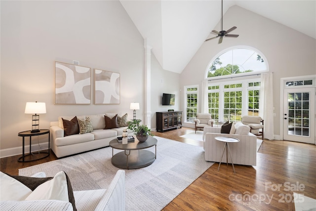 living room with high vaulted ceiling, wood finished floors, and a ceiling fan