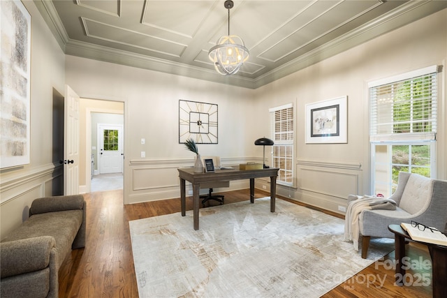 office featuring crown molding, a decorative wall, an inviting chandelier, and wood finished floors