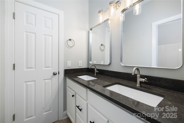 bathroom featuring double vanity and a sink