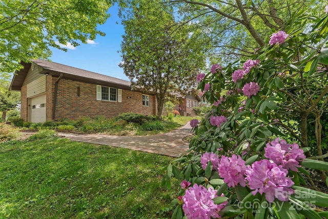 view of home's exterior featuring a lawn and brick siding