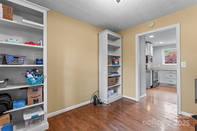 interior space with baseboards and wood finished floors